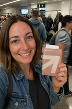 Pink passport holder at a busy airport gate